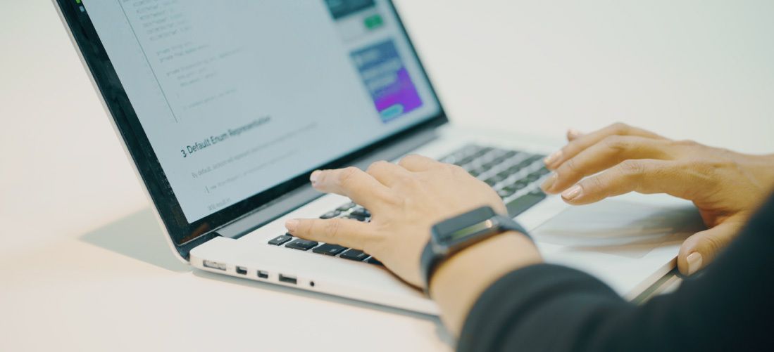 Someone typing on a laptop